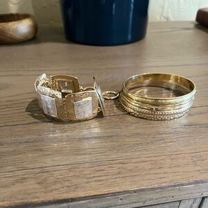 Bracelets!! One-silver and gold tones..One-a set of gold tone bangle bracelets.